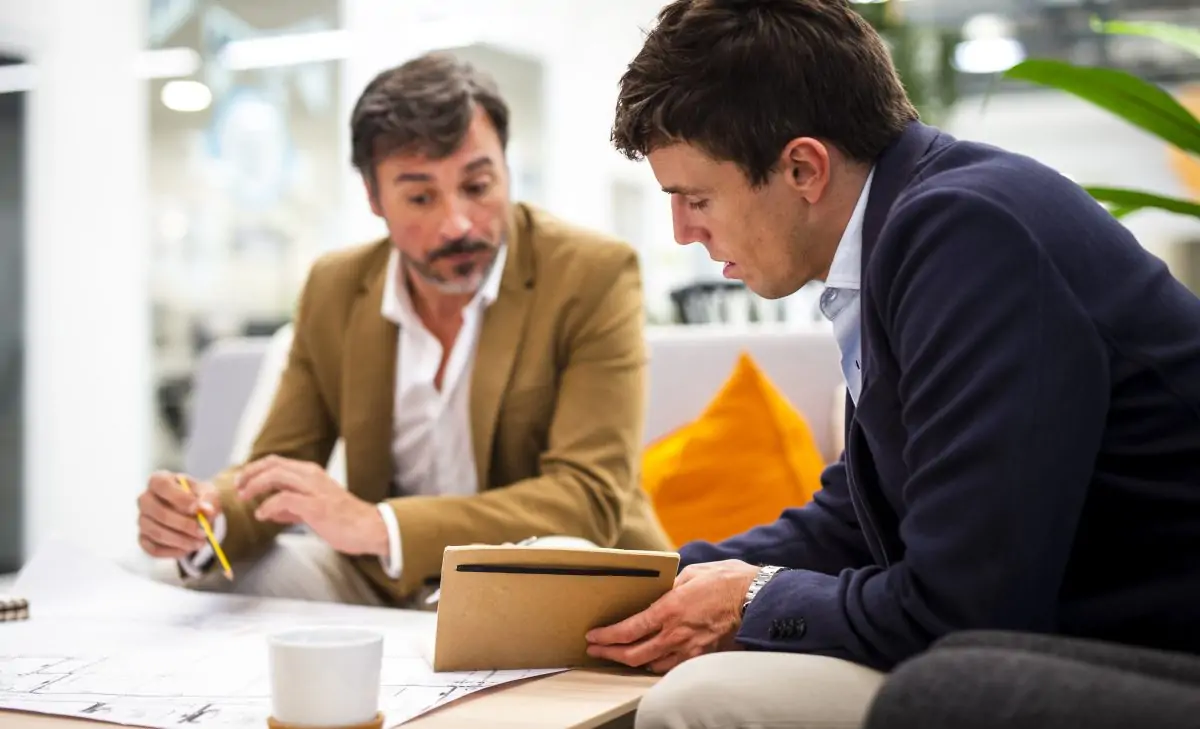low-angle-male-coworkers-planning-sketches